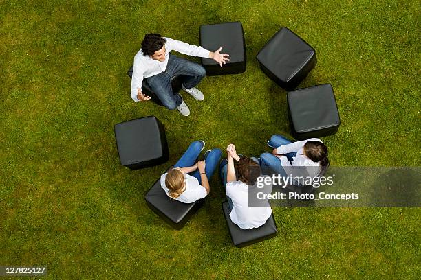 people talking in circle in grass - overhead view meeting stock pictures, royalty-free photos & images