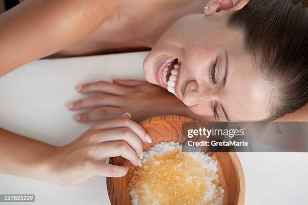 woman playing with bowl of sugar - bath salt stock pictures, royalty-free photos & images