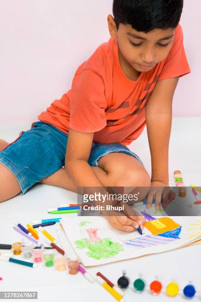 boy making colorful house drawing with colors. - kid holding crayons stock pictures, royalty-free photos & images