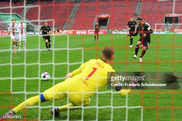 Lars Stindl of Borussia Monchengladbach scores a penalty for his team's third goal past Timo Horn of 1. FC Koeln during the Bundesliga match between...