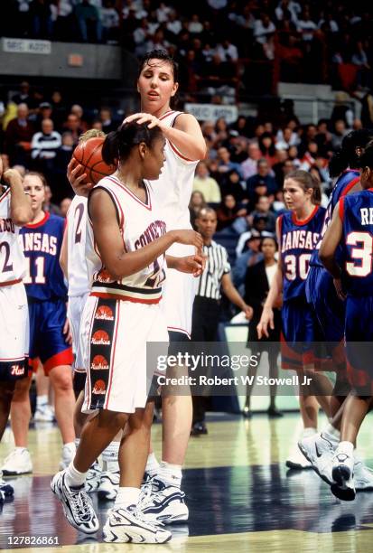 American basketball player Kara Wolters, of the University of Connecticut, gives teammate Rita Williams a pat on head, during a game against the...