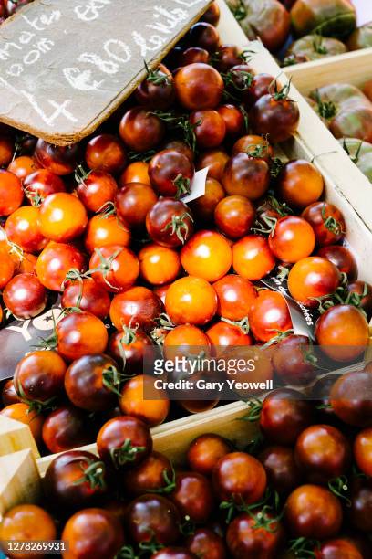 display of cherry tomatoes on a market stall - lyon shopping stock pictures, royalty-free photos & images