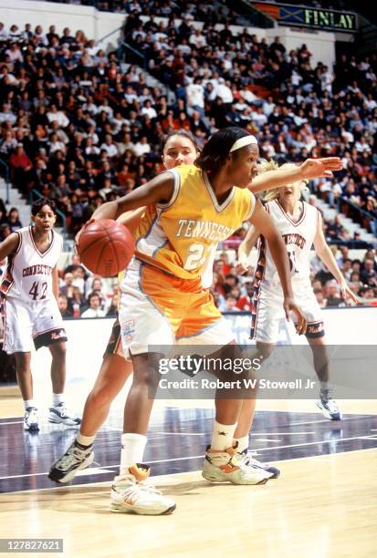 American basketball player Chamique Holdsclaw, of the University of Tennessee, with the ball during a game against the University of Connecticut,...