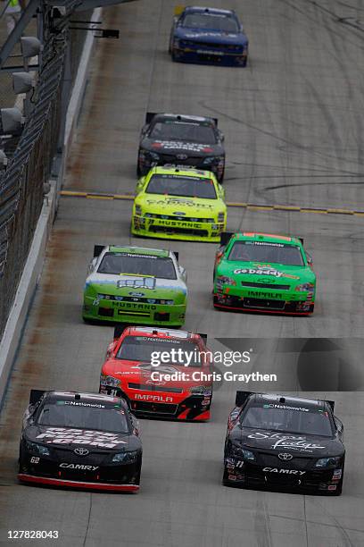 Michael Annett, driver of the RaceWithRusty.com Toyota and Brian Scott, driver of the Shore Lodge Toyota, lead a pack of cars during the NASCAR...