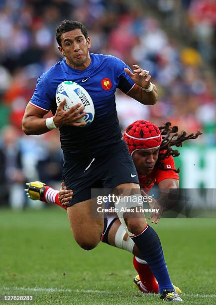 Maxime Mermoz of France escapes the tackle from Paino Hehea of Tonga during the IRB 2011 Rugby World Cup Pool A match between France and Tonga at...