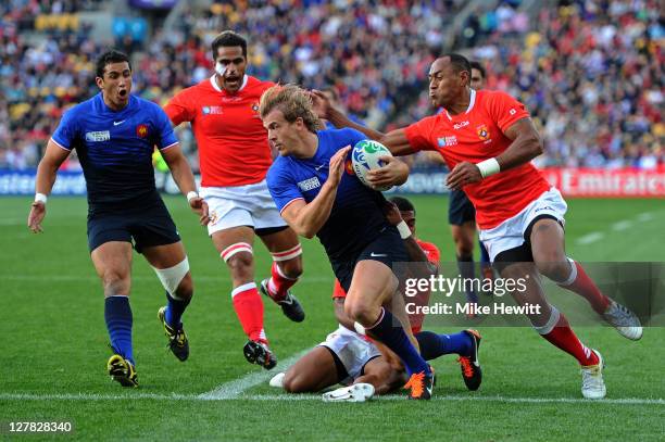 Centre Aurelien Rougerie of France is hauled down by the Tonga defence during the IRB 2011 Rugby World Cup Pool A match between France and Tonga at...