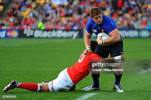 Lock Pascal Pape of France is brought down by Siale Piutau of Tonga during the IRB 2011 Rugby World Cup Pool A match between France and Tonga at...