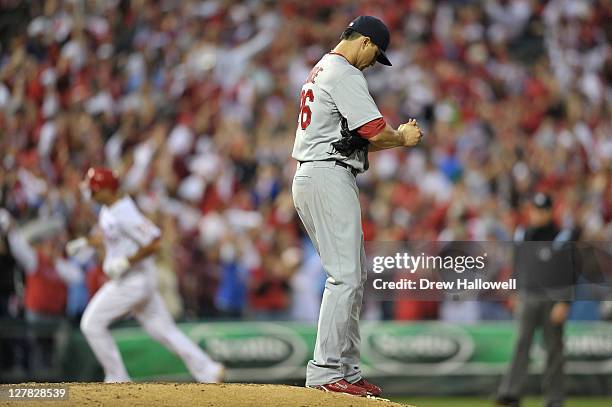 Kyle Lohse of the St. Louis Cardinals stands on the mound as Raul Ibanez of the Philadelphia Phillies rounds the bases after hitting a two-run home...