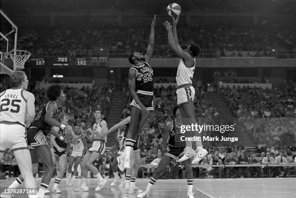 David Thompson of the Denver Nuggets shoots a jumper over Ken Smith in an ABA game against the San Antonio Spurs at McNichols Arena on January 23,...