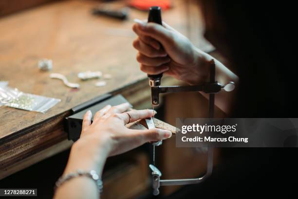 rear view of asian korean female student using hand saw in college workbench - jeweller tools stock pictures, royalty-free photos & images