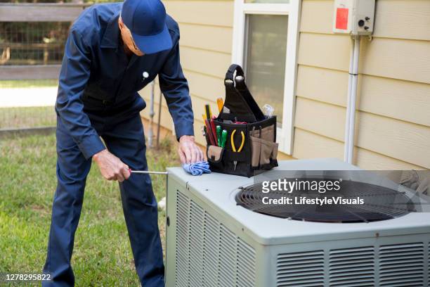technician services outside ac units and generator. - ventilador imagens e fotografias de stock