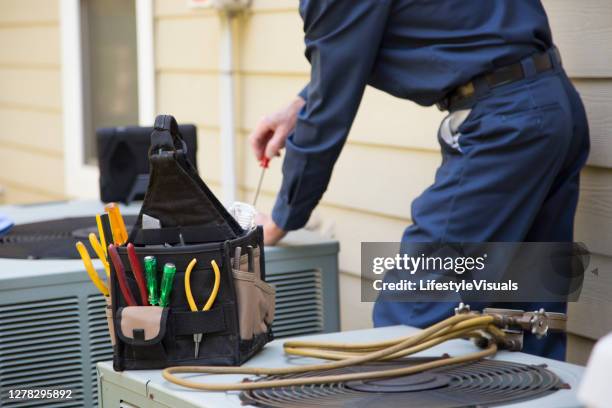 technician services outside ac units and generator. - ac repair stock pictures, royalty-free photos & images