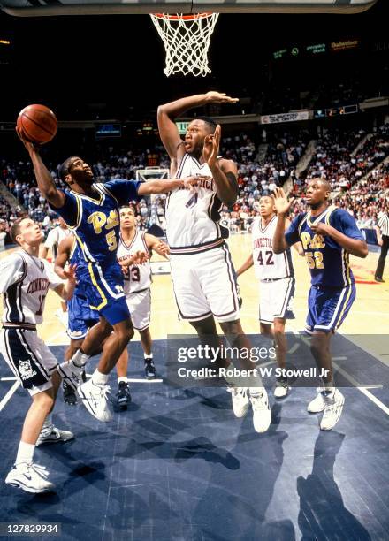 American basketball player Boo Willingham of the University of Connecticut jumps to block a shot by an unidentified playre from the University of...