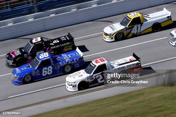 Spencer Boyd, driver of the Alabama Roofing Professionals Chevrolet, Clay Greenfield, driver of the Rackley Roofing Toyota, Joe Nemechek, driver of...