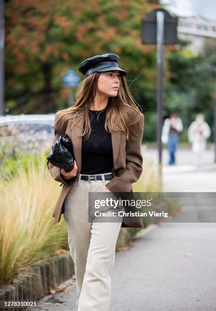 Sophia Roe seen wearing black baker boy hat, brown blazer, creme white corduroy pants outside Hermes during Paris Fashion Week - Womenswear Spring...