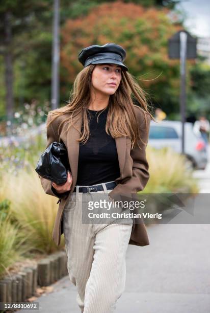 Sophia Roe seen wearing black baker boy hat, brown blazer, creme white corduroy pants outside Hermes during Paris Fashion Week - Womenswear Spring...