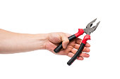 Pliers in a hand on a white background. Hand is holding universal pliers on white background