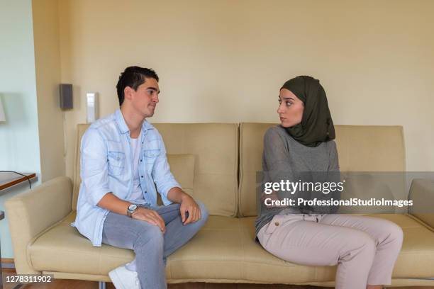 young multicultural couple is debating about the problems in relationship. - angry couple arab stock pictures, royalty-free photos & images