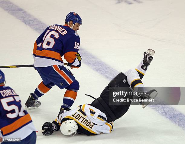 Marty Reasoner of the New York Islanders steps into Benoit Pouliot of the Boston Bruins at the Webster Bank Arena on October 1, 2011 in Bridgeport,...