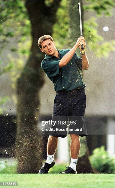 Michael Owen of England watches as his miss hit his tee shot on the Par 3 opening hole at the golf course at their World Cup base in La Baule,...