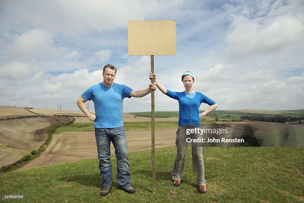 Couple holding hill top protest