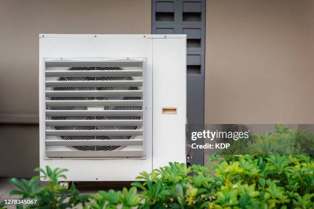 condensing fan installing outside building exterior of air conditioner. - installation art stock-fotos und bilder