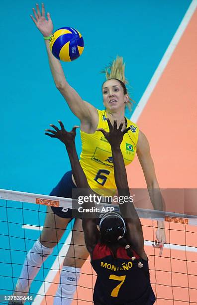 Brazil's Thaisa Menezes spikes the ball against Colombia's Madelaynne Montano, during their 2011 Women's South American Volleyball Championship...