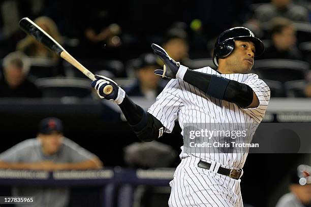 Robinson Cano of the New York Yankees watches his grand slam home run in the sixth inning of Game One of the American League Division Series against...
