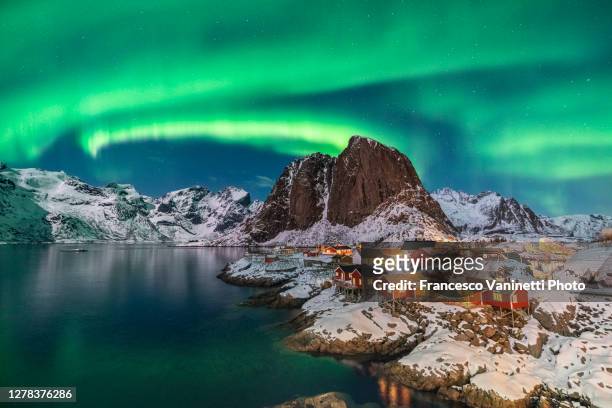 northern lights above festhelltinden peak and hamnoy, lofoten islands. - light natural phenomenon stock pictures, royalty-free photos & images