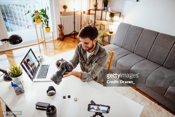 vlogger testing new camera and lens - man recording himself in living room - digital single lens reflex camera stock pictures, royalty-free photos & images