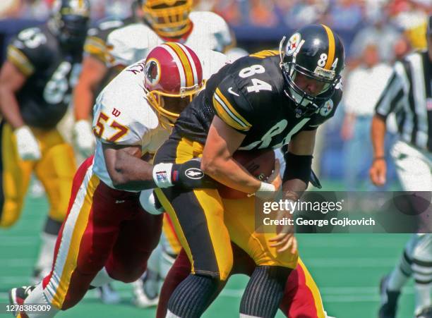 Linebacker Ken Harvey of the Washington Redskins tackles tight end Kirk Botkin of the Pittsburgh Steelers during a game at Three Rivers Stadium on...