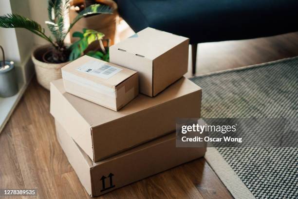 parcels on floor in a living room - parcel delivery stock pictures, royalty-free photos & images