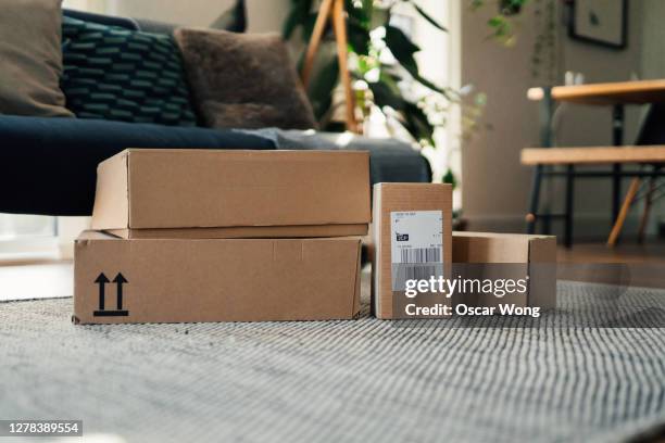 parcels on floor in a living room - merchandise table stock pictures, royalty-free photos & images