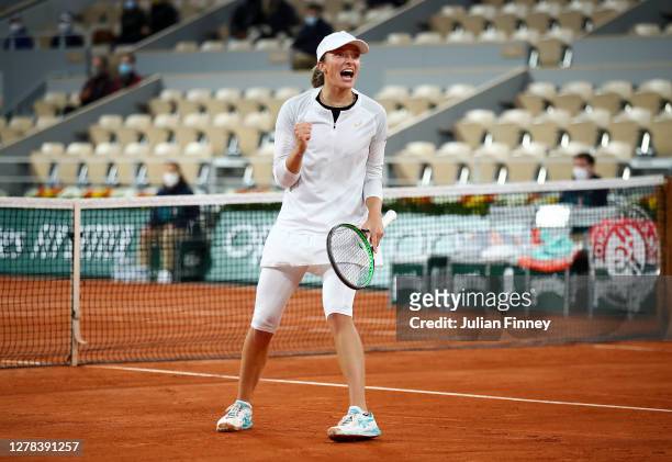 Iga Swiatek of Poland celebrates after winning match point during her Women's Singles fourth round match against Simona Halep of Romania on day eight...