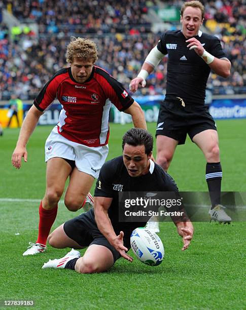 Wing Zac Guildford of the All Blacks pounces on a mistake by wing Conor Trainor of Canada to score his team's fourth try during the IRB Rugby World...