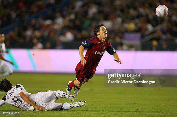 Omar Gonzalez of the Los Angeles Galaxy tackles Will Johnson of Real Salt Lake in the first half during the MLS match at The Home Depot Center on...