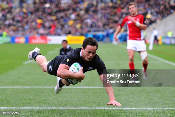 Wing Zac Guildford of the All Blacks dives over the line to score score his team's sixth try and complete his first half hat trick during the IRB...