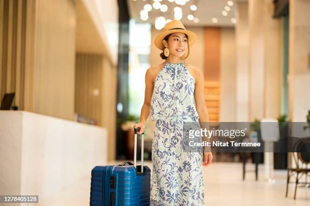beautiful asian tourist women arriving while walking to check in at a hotel lobby. - daily life in bangkok photos et images de collection