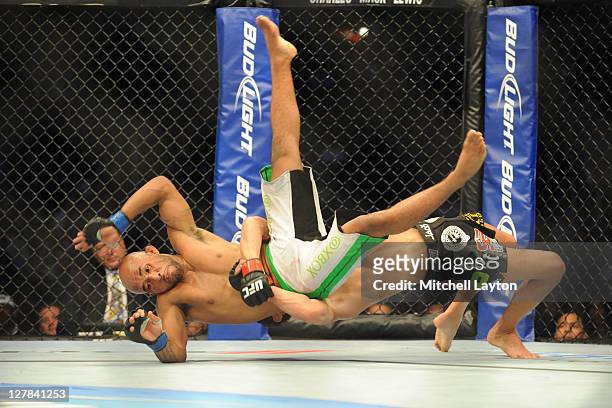 Dominick Cruz takes down Demetrious Johnson during the UFC Bantamweight title fight on Versus event at the Verizon Center on October 1, 2011 in...