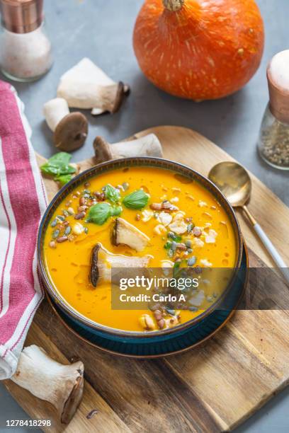 a creamy soup or velloute of butternut squash with seeds and mushrooms - kürbissuppe stock-fotos und bilder
