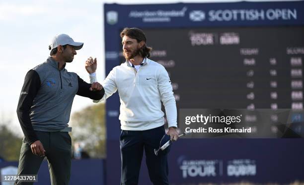 Tommy Fleetwood of England congratulates Aaron Rai of England after winning on the first play-off hole during the final round of the Aberdeen...