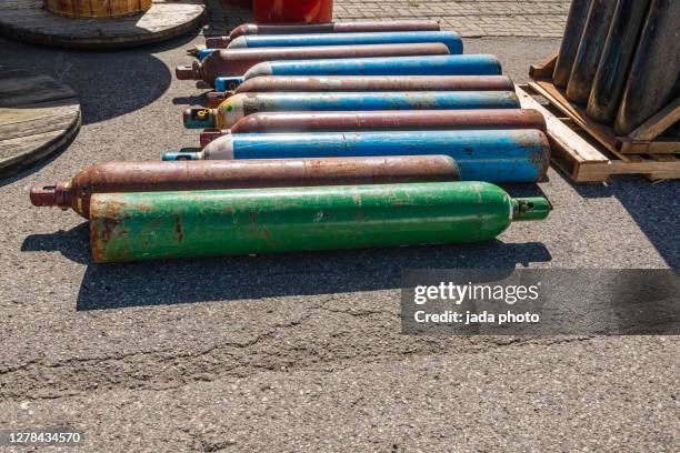 steel nitrogen cylinders lying horizontal - tone tank stock pictures, royalty-free photos & images