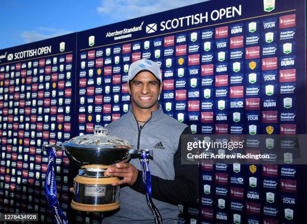 Aaron Rai of England poses with the trophy after beating Tommy Fleetwood of England in a one hole play-off to win the Aberdeen Standard Investments...