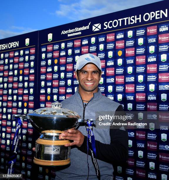 Aaron Rai of England poses with the trophy after beating Tommy Fleetwood of England in a one hole play-off to win the Aberdeen Standard Investments...