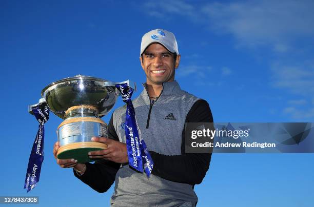 Aaron Rai of England poses with the trophy after beating Tommy Fleetwood of England in a one hole play-off to win the Aberdeen Standard Investments...