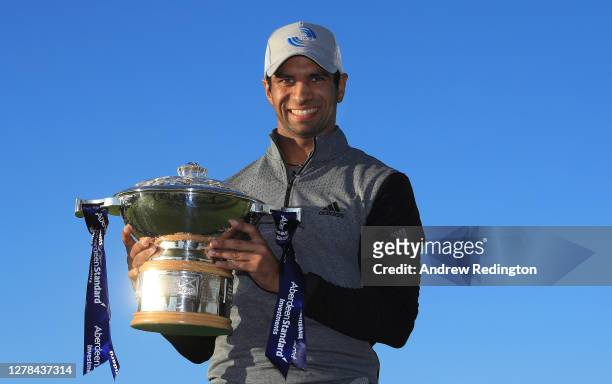 Aaron Rai of England poses with the trophy after beating Tommy Fleetwood of England in a one hole play-off to win the Aberdeen Standard Investments...
