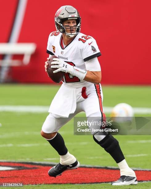 Tom Brady of the Tampa Bay Buccaneers warms up before the start of a game against the Los Angeles Chargers at Raymond James Stadium on October 04,...
