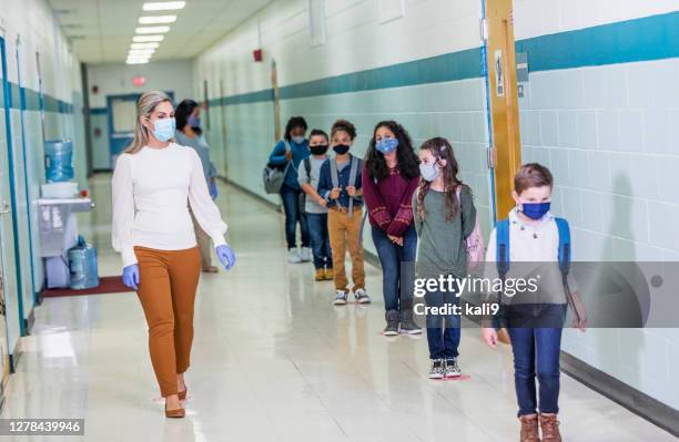 students in school during covid-19, wearing masks - social distancing kids stock pictures, royalty-free photos & images