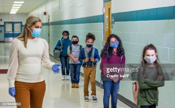 students in school during covid-19, wearing masks - kids lining up stock pictures, royalty-free photos & images
