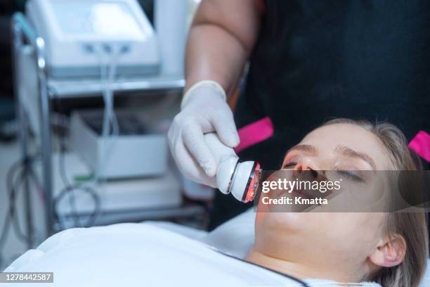 light therapy facial treatment - electrolysis stock pictures, royalty-free photos & images